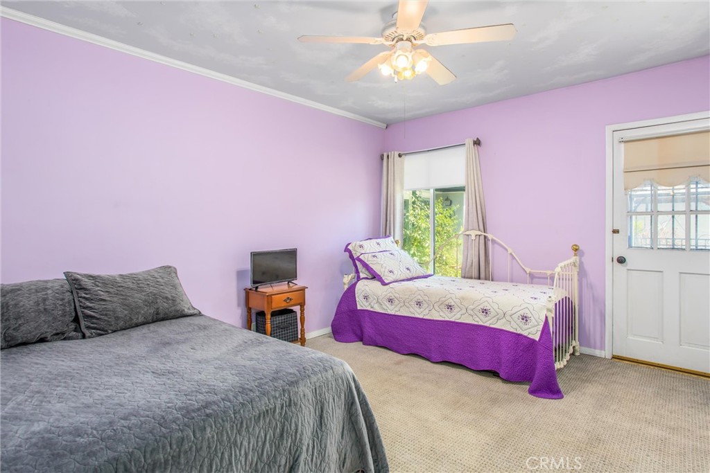 3095 Pepper Tree Lane San Bernardino, CA 92404 - Photo 16 of 29 a bedroom with a bed and a chandelier
