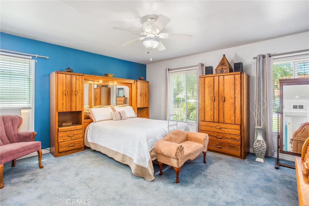 3095 Pepper Tree Lane San Bernardino, CA 92404 - Photo 19 of 29 a bedroom with a bed and a chandelier
