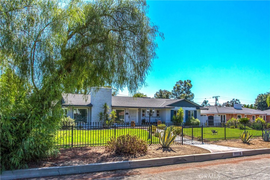 3095 Pepper Tree Lane San Bernardino, CA 92404 - Photo 2 of 29 a front view of house with a yard and potted plants