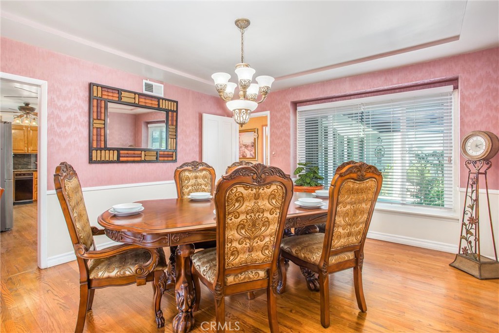 3095 Pepper Tree Lane San Bernardino, CA 92404 - Photo 7 of 29 a view of a dining room with furniture and chandelier