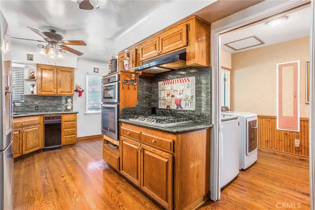 a kitchen with stainless steel appliances granite countertop a stove and a refrigerator