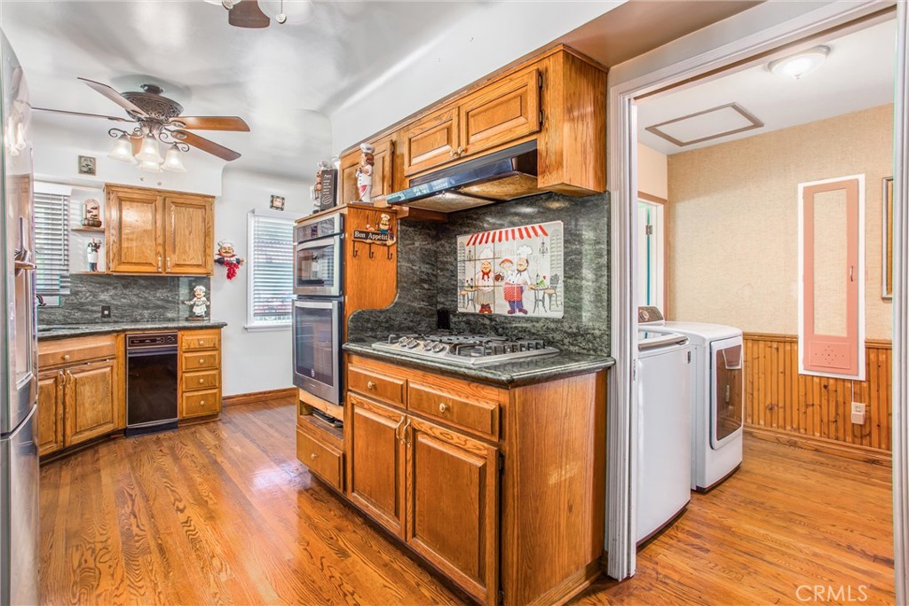 3095 Pepper Tree Lane San Bernardino, CA 92404 - Photo 8 of 29 a kitchen with stainless steel appliances granite countertop a stove and a refrigerator