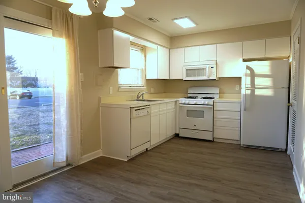 a kitchen with a stove a sink and a refrigerator