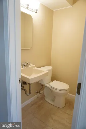 a white toilet sitting next to a bathroom sink