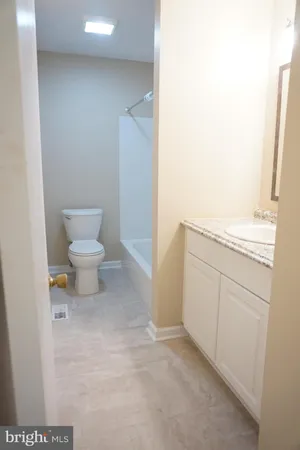 a bathroom with a sink a toilet and a vanity