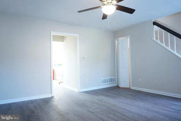 a view of an empty room with wooden floor