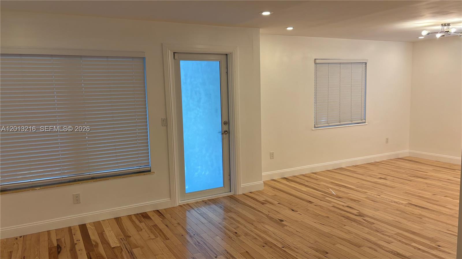 250 Southwest 19th Road Miami, FL 33129 - Photo 3 of 22 a view of an empty room with wooden floor and a window