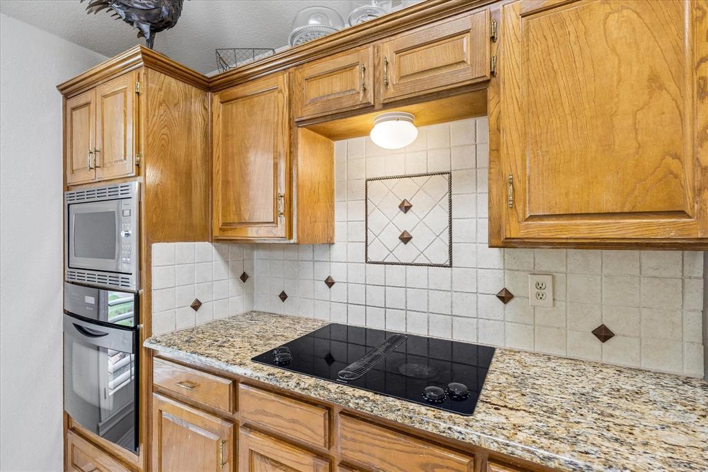 404 Moonlight Lane Keller, TX 76248 - Photo 18 of 40 a kitchen with granite countertop cabinets and window
