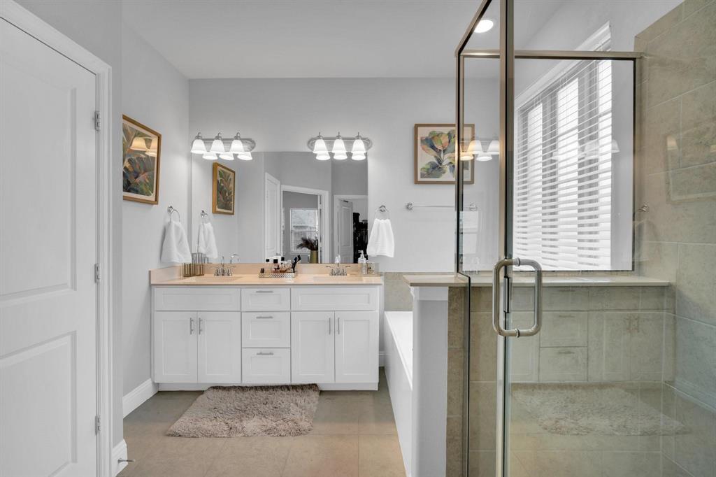 1498 Weston Road Dallas, TX 75234 - Photo 15 of 24 Dual vanity with white cabinetry and light-toned countertops