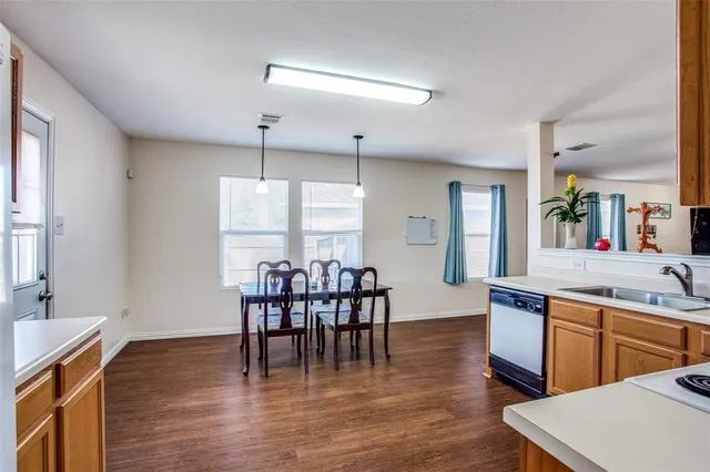 a view of a dining room with furniture and wooden floor