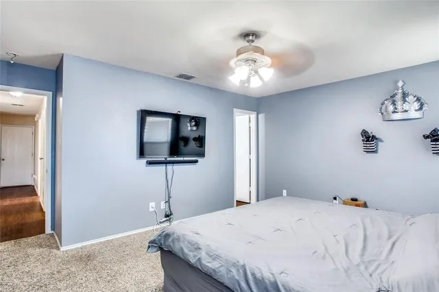 a spacious bedroom with a bed and a window