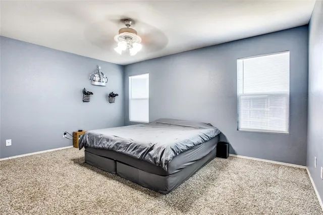 a bedroom with a bed and window