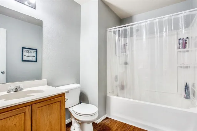 an empty room with windows and ceiling fan