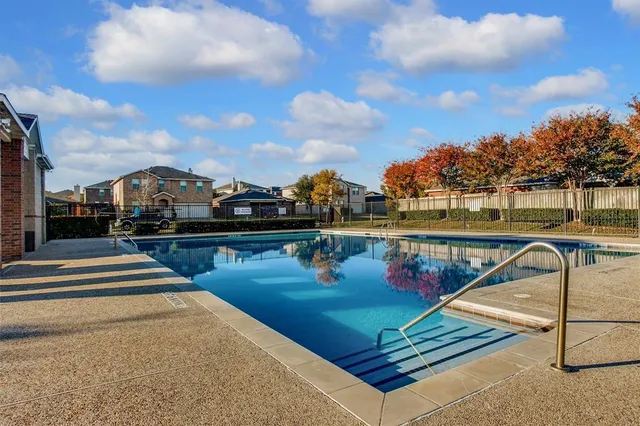 a front view of a house with yard and tress