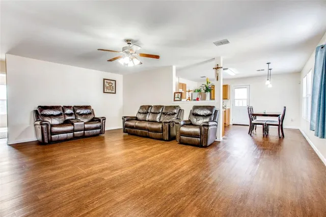 a living room with furniture and wooden floor