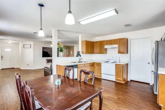 a large kitchen with a table and chairs