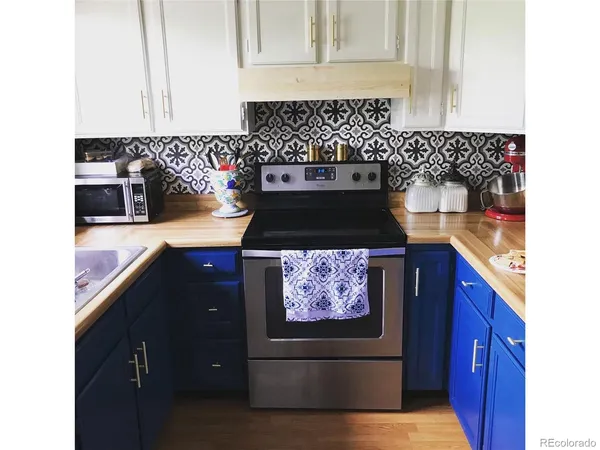 a kitchen with a stove and cabinets