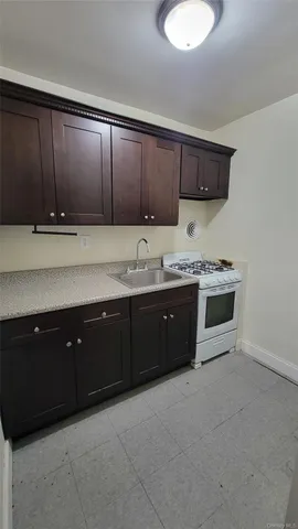 a spacious bathroom with a granite countertop double vanity and a mirror
