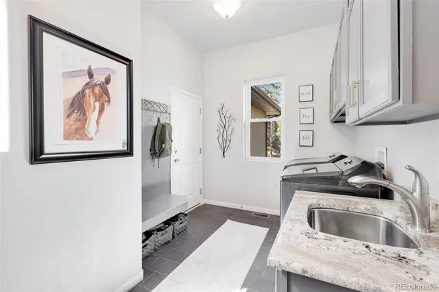 a kitchen with a refrigerator sink and cabinets