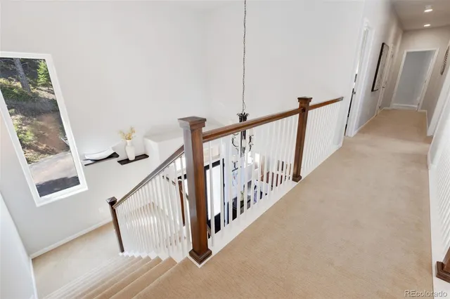 a view of staircase with railing and stairs