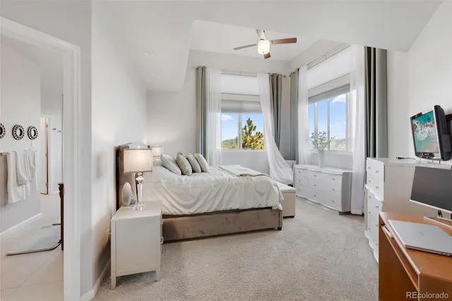 a spacious bedroom with a bed and a couch