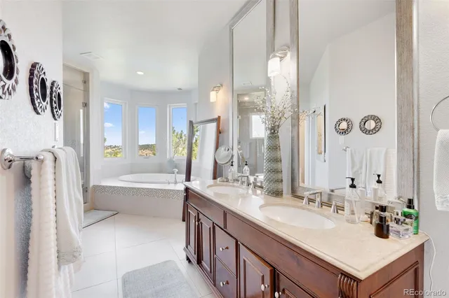 a bathroom with a tub sink and mirror