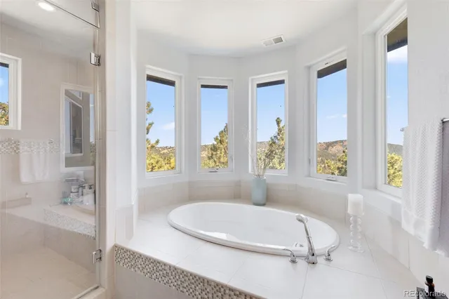 a bath tub sitting in a bathroom next to a window