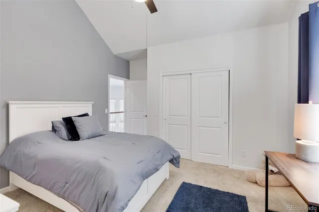 a bedroom with a bed and a night stand