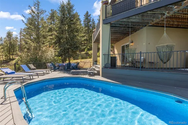 a view of swimming pool with outdoor seating