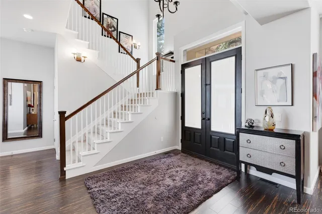 a view of entryway and hall with wooden floor