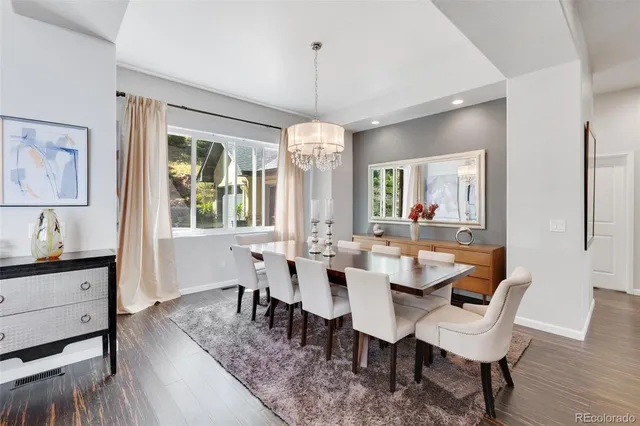 a view of a a dining room with furniture window and wooden floor