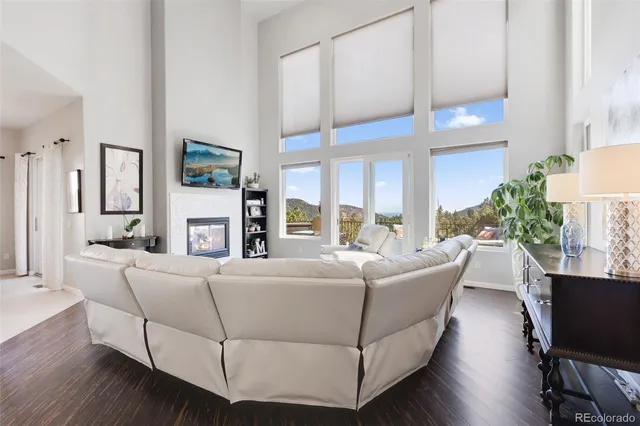 a living room with furniture a fireplace and a table
