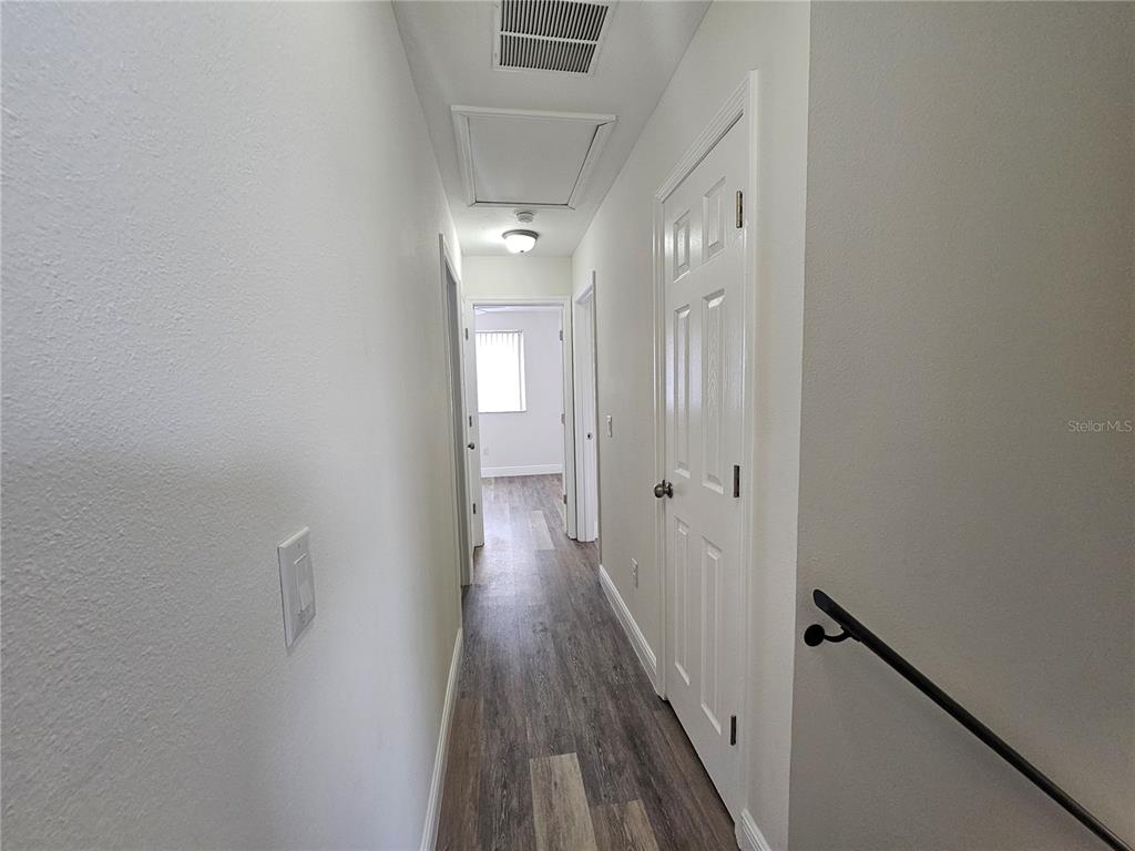 411 Australian Way Davenport, FL 33897 - Photo 12 of 24 a view of a hallway with wooden floor and staircase