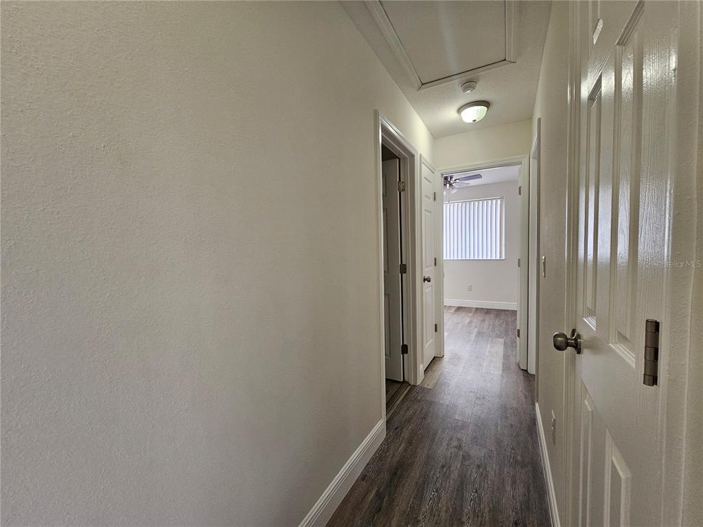 411 Australian Way Davenport, FL 33897 - Photo 13 of 24 a view of a hallway with wooden floor