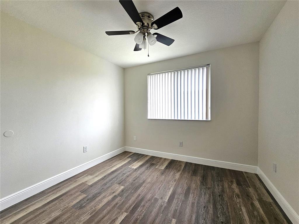 411 Australian Way Davenport, FL 33897 - Photo 20 of 24 an empty room with a window and a ceiling fan