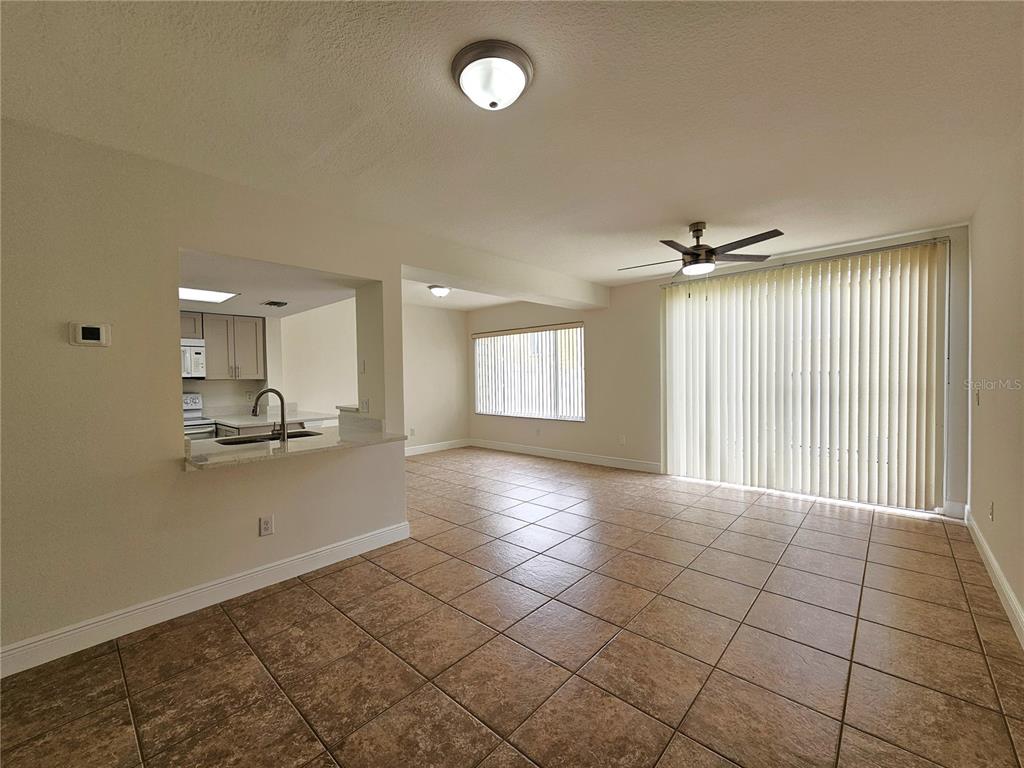 411 Australian Way Davenport, FL 33897 - Photo 2 of 24 a view of a kitchen with a sink and a window