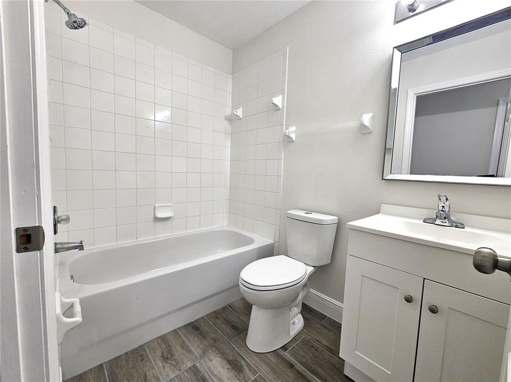 411 Australian Way Davenport, FL 33897 - Photo 22 of 24 a bathroom with a sink toilet and shower