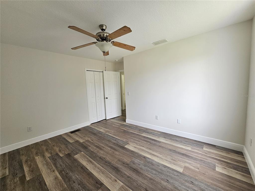 411 Australian Way Davenport, FL 33897 - Photo 23 of 24 a view of empty room with wooden floor
