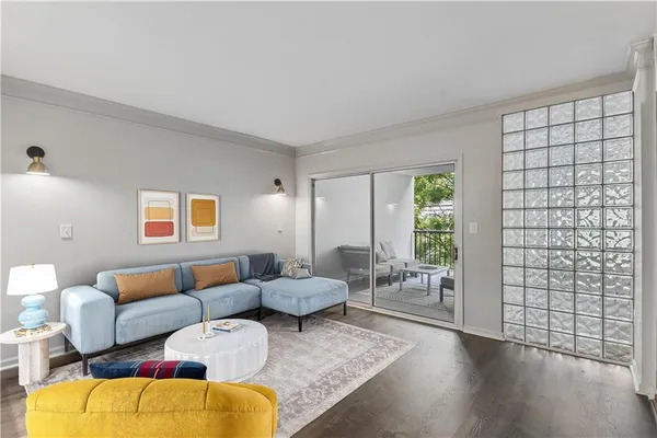 a living room with furniture window and wooden floor