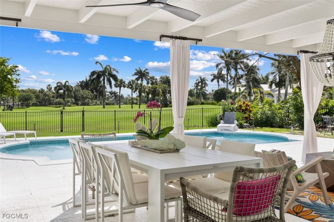 2728 Crayton Road Naples, FL 34103 - Photo 12 of 35 a view of a patio with a table chairs and a backyard