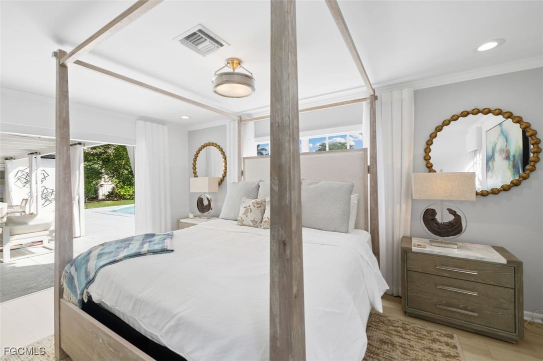 2728 Crayton Road Naples, FL 34103 - Photo 20 of 35 a bedroom with a bed and a mirror