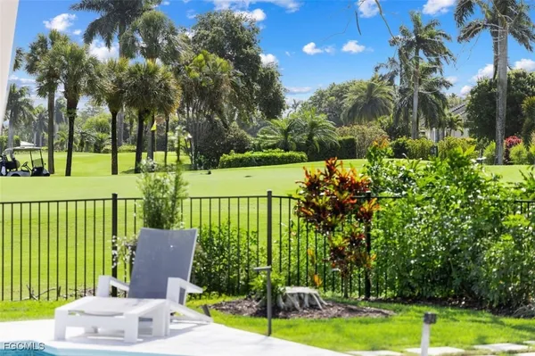 a view of a porch with furniture and garden