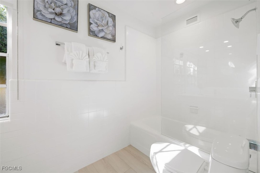 2728 Crayton Road Naples, FL 34103 - Photo 25 of 35 a bathroom with a toilet