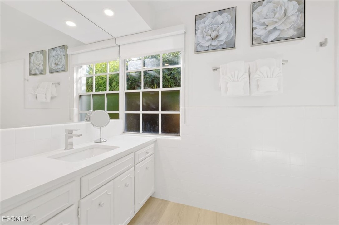 2728 Crayton Road Naples, FL 34103 - Photo 26 of 35 a bathroom with a sink and a window