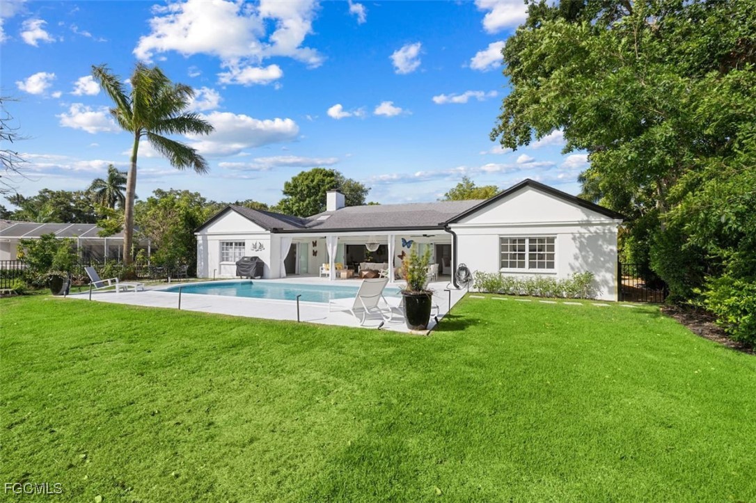 2728 Crayton Road Naples, FL 34103 - Photo 28 of 35 a front view of a house with a yard and porch