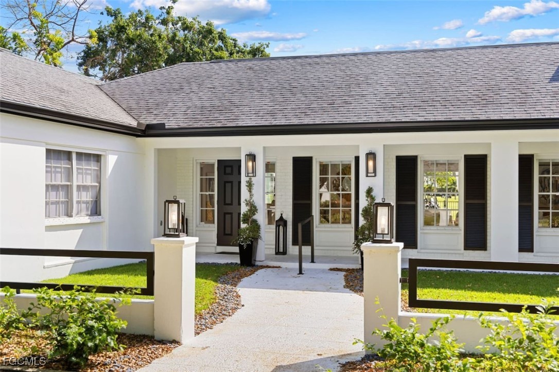 2728 Crayton Road Naples, FL 34103 - Photo 31 of 35 a front view of a house with a garden