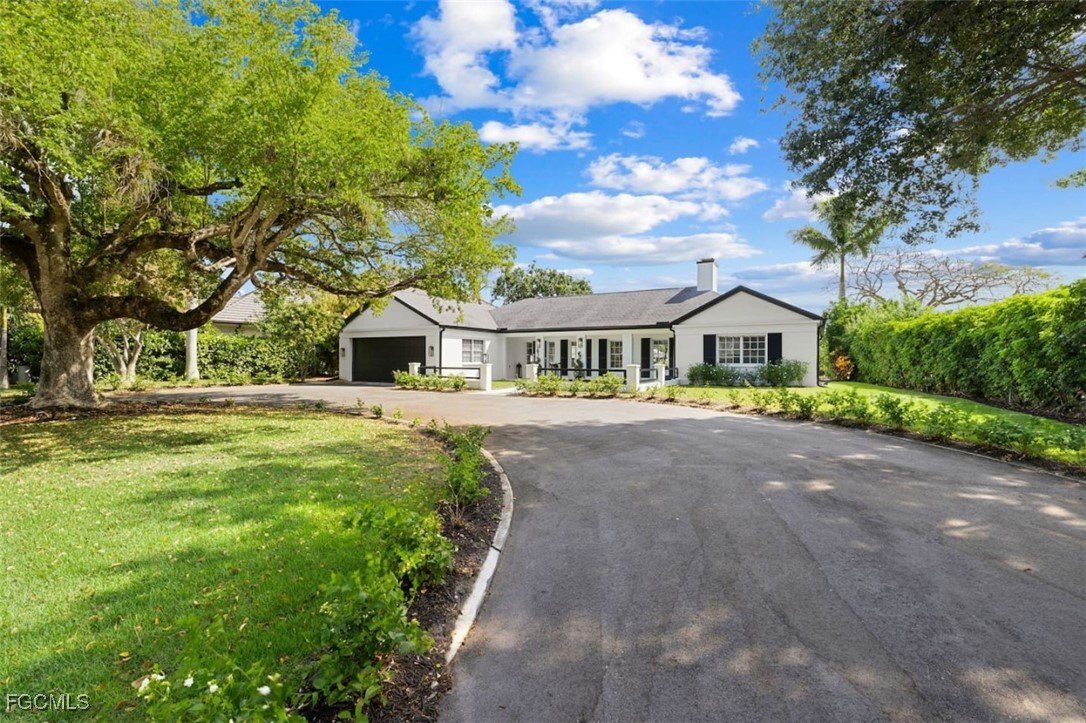 2728 Crayton Road Naples, FL 34103 - Photo 32 of 35 a front view of house with yard