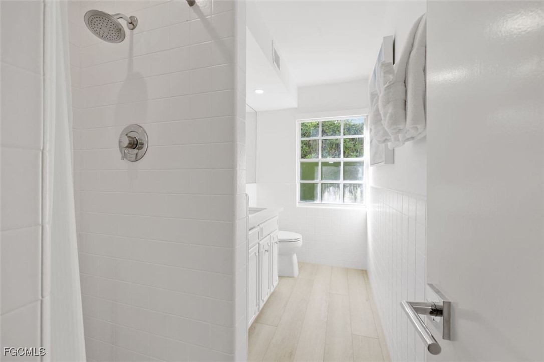 2728 Crayton Road Naples, FL 34103 - Photo 35 of 35 a bathroom with a window and a shower