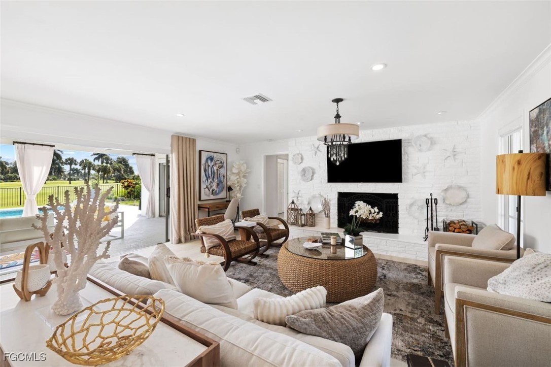 2728 Crayton Road Naples, FL 34103 - Photo 4 of 35 a living room with furniture a fireplace and a flat screen tv