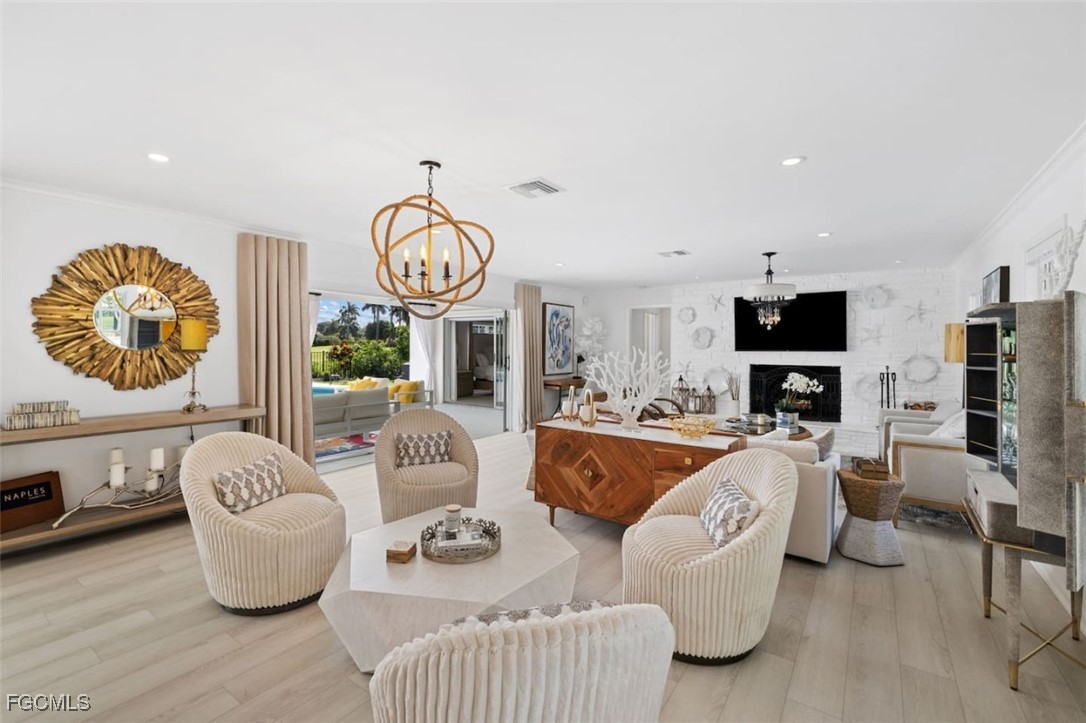 2728 Crayton Road Naples, FL 34103 - Photo 6 of 35 a living room with furniture a fireplace and a flat screen tv